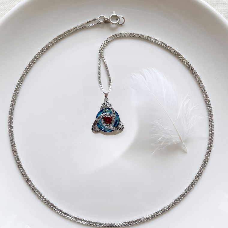 The pendant next to a white feather