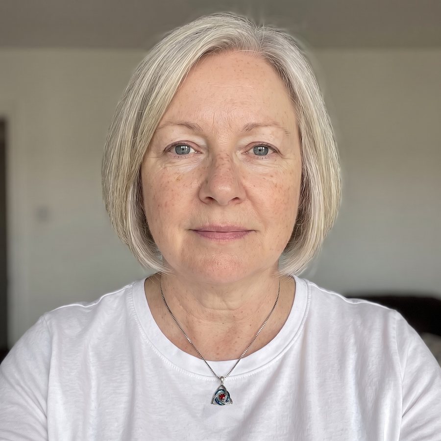 A woman wearing the necklace, the birthstone heart at its centre