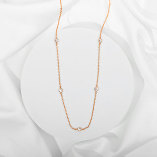 Avera diamond station necklace in rose gold - flat on silk
