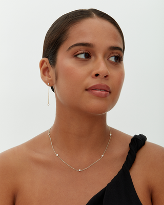 Avera diamond station necklace in white gold - worn, side profile