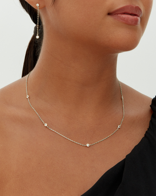 Avera diamond station necklace in white gold - worn on a neckline