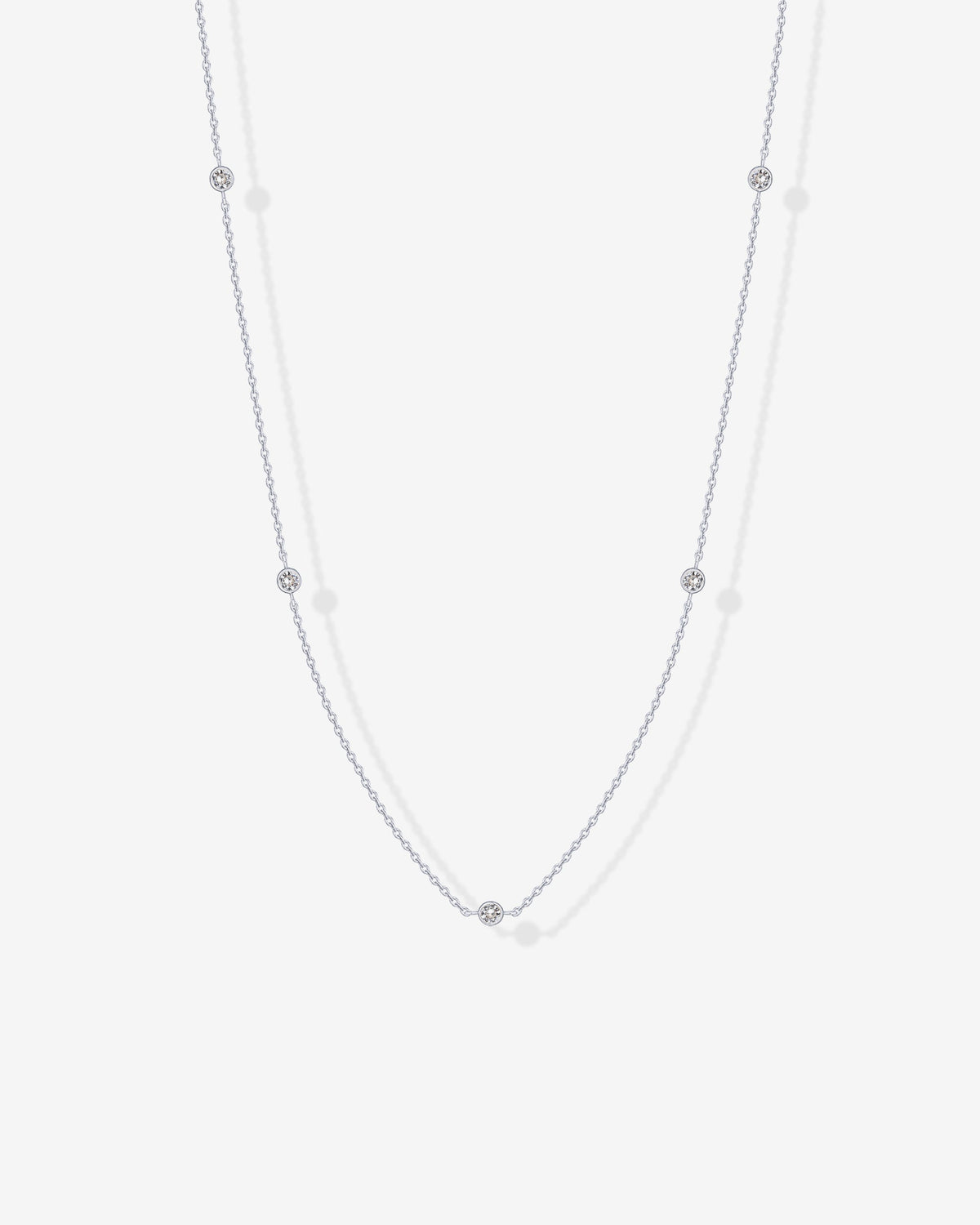Avera diamond station necklace in white gold - worn close up