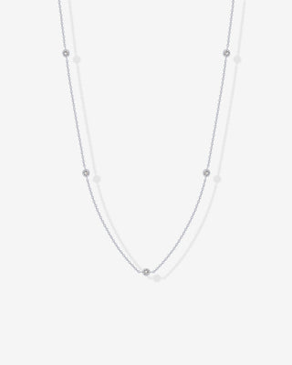 Avera diamond station necklace in white gold - worn close up