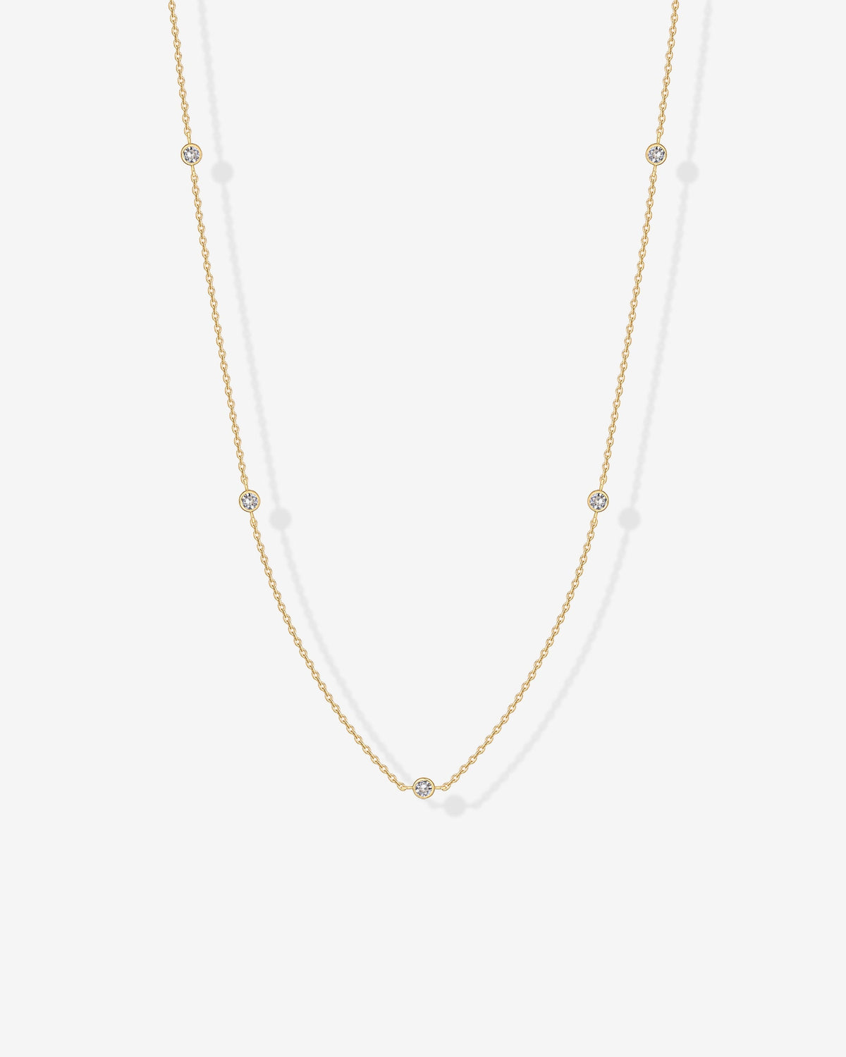 Avera diamond station necklace in yellow gold - worn close up