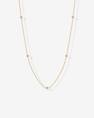 Avera diamond station necklace in yellow gold - worn close up