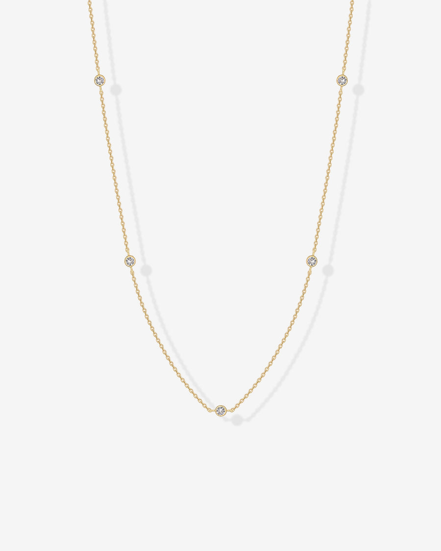 Avera diamond station necklace in yellow gold - worn close up