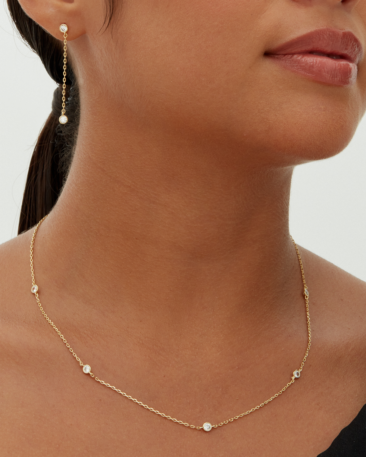 Avera diamond station necklace in yellow gold - worn on a neckline