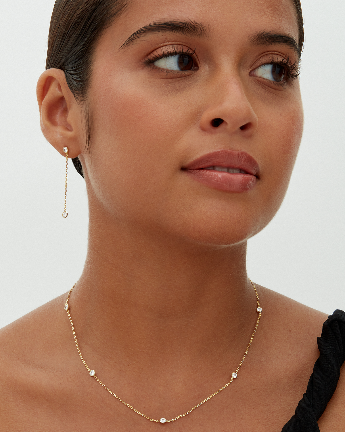 Avera diamond station necklace in yellow gold - worn, side profile
