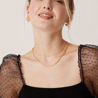 Avera diamond station necklace in yellow gold - worn, smiling model