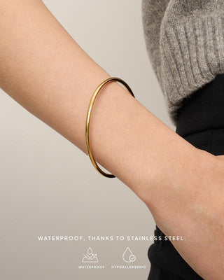 Gold bangle on the arm — waterproof stainless steel