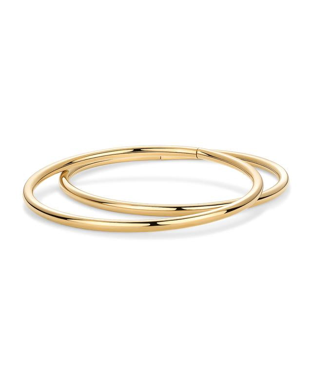 Two gold bangles showing the hinge