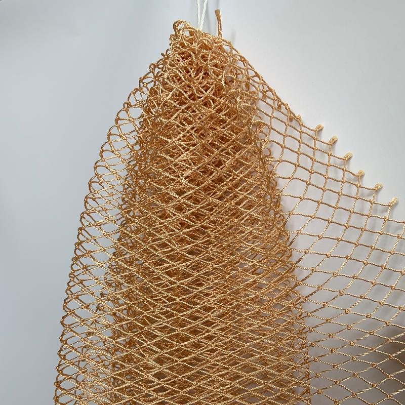 African exfoliating net in tan, hanging