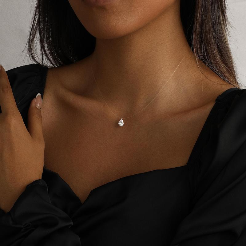 Pear floating pendant necklace held in hand