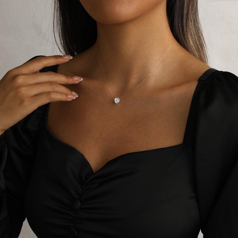 Heart floating pendant necklace held in hand