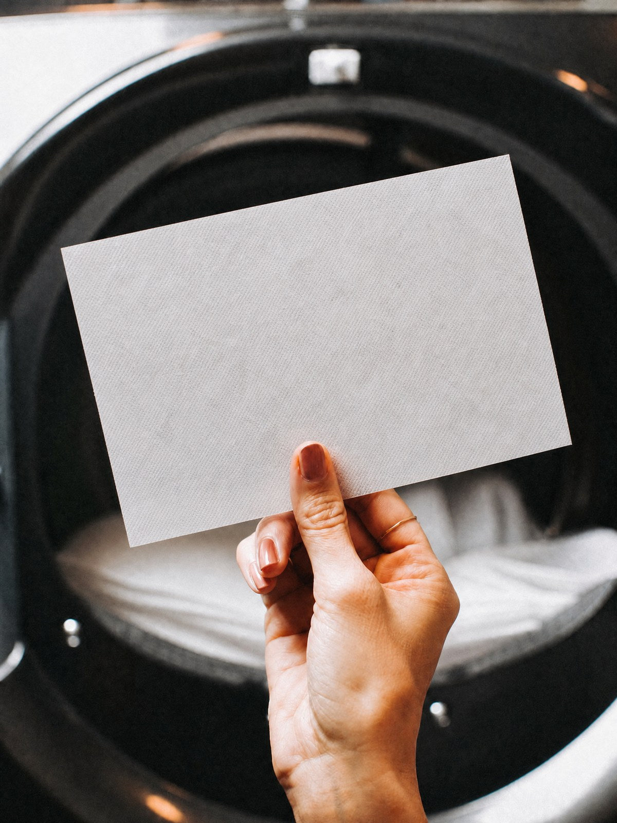 Holding a laundry sheet in front of the washing machine