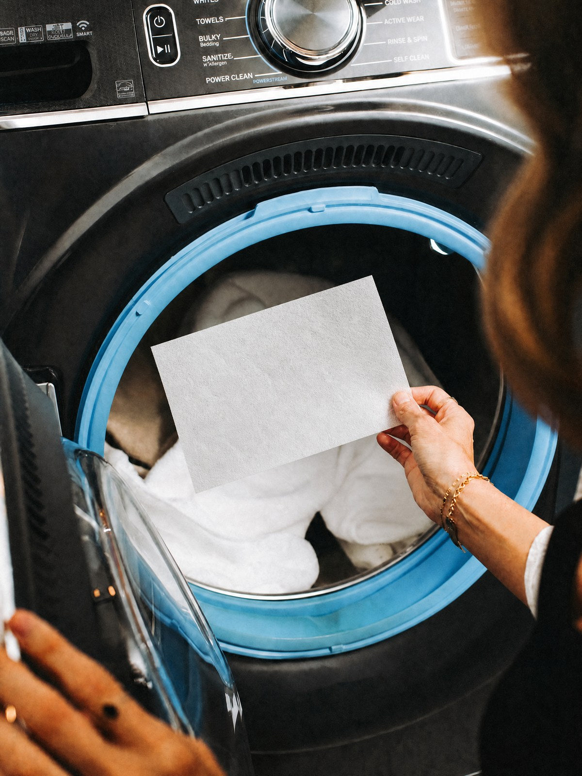 Tossing a laundry sheet in with the load