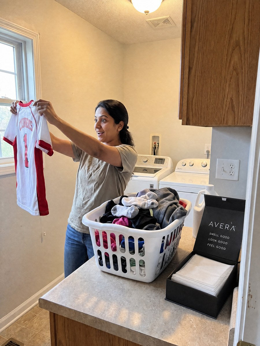 Tossing an Avera laundry sheet in with the load Image
