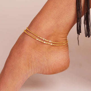 Gold anklet worn