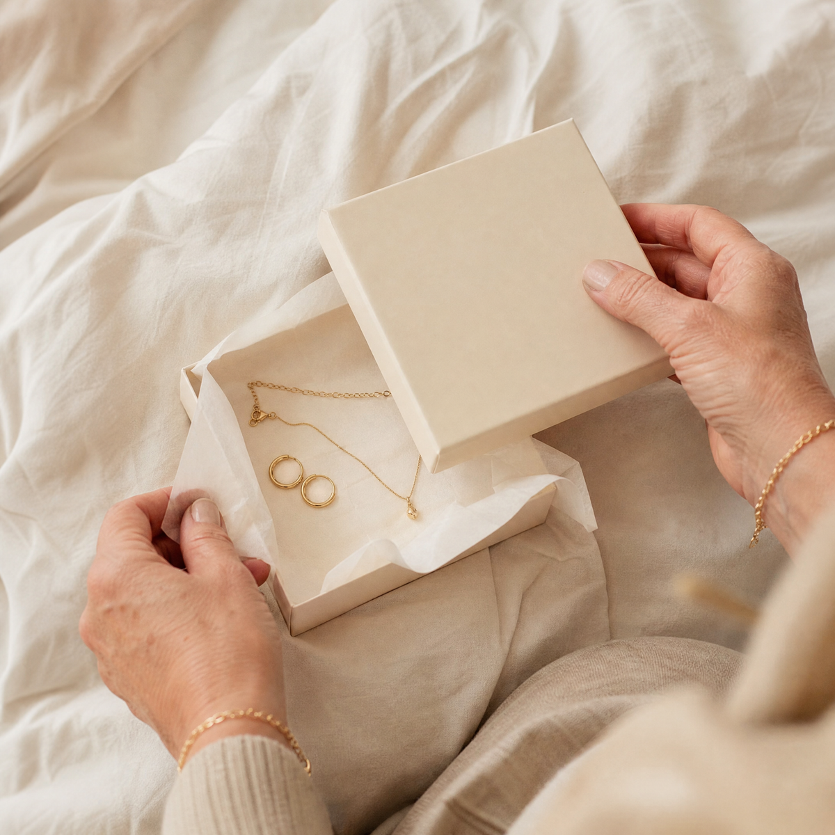 Opening a gift box of delicate gold jewelry Image