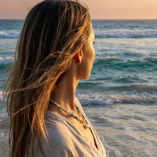 Woman at the shoreline at sunset wearing the Turquoise Bead Pearl Necklace