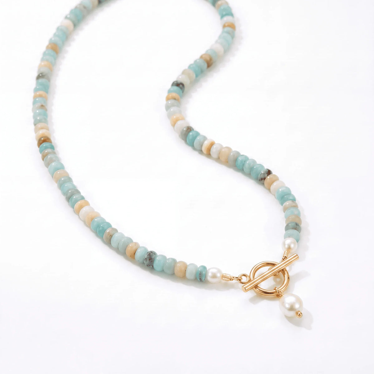Close up of the gold toggle clasp and pearl drop on the Turquoise Bead Pearl Necklace