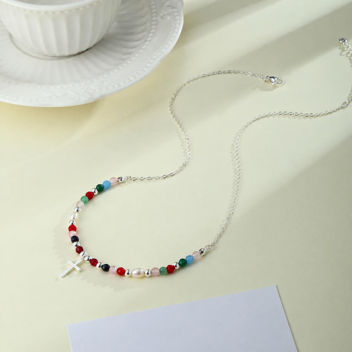 Silver-tone Faith Cross Necklace on a table