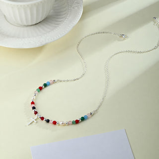 Silver-tone Faith Cross Necklace on a table