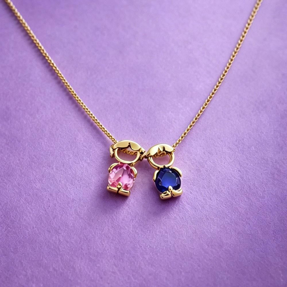 Girl and boy charms on a gold chain