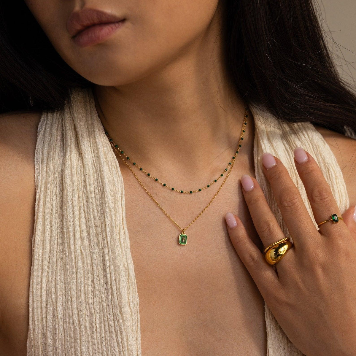 North Star birthstone necklace worn layered