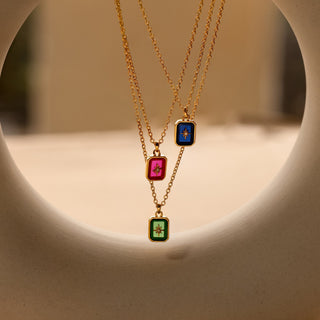 Three North Star birthstone pendants stacked