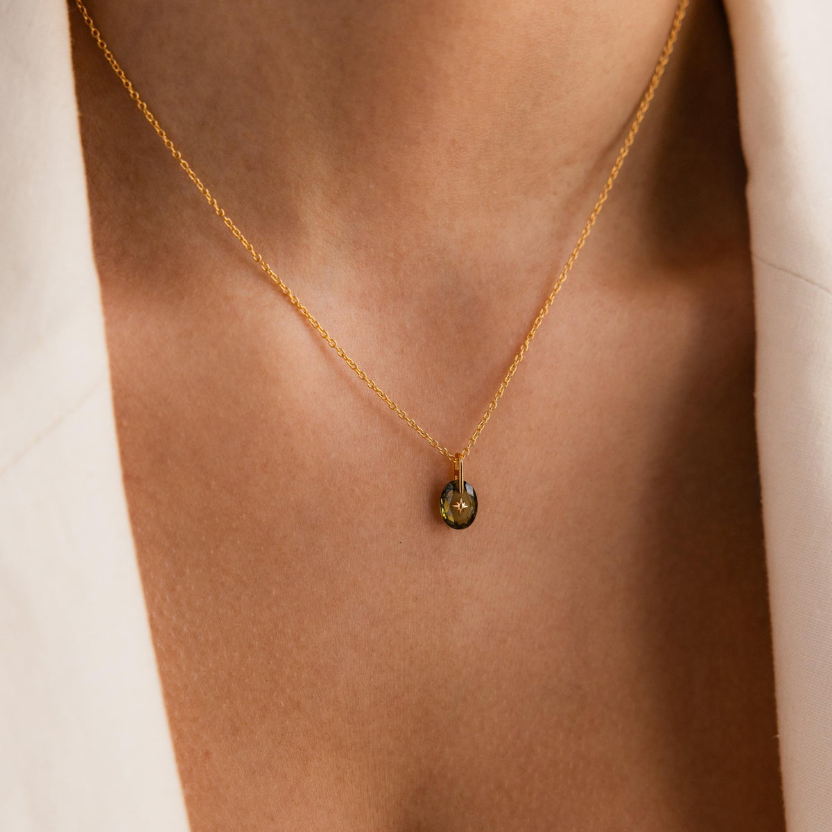 Oval North Star birthstone pendant worn