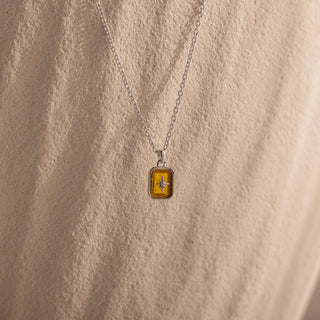 Silver-tone rectangle North Star pendant worn