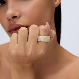 Woman wearing the gold Avera Pave Smart Ring Cover on her index finger