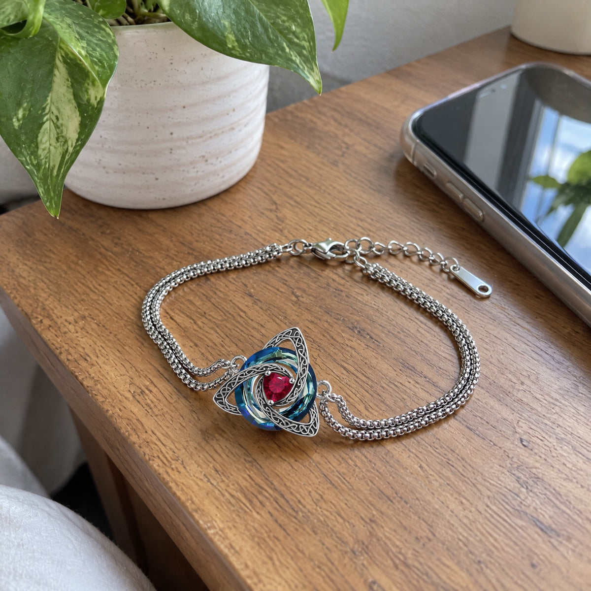Witch knot birthstone bracelet on a bedside table
