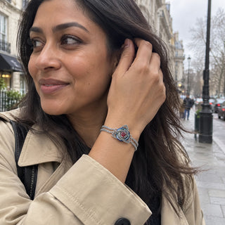 Woman in a city street wearing the witch knot birthstone bracelet