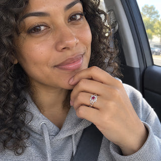 Woman in a car wearing the witch knot birthstone ring on her index finger