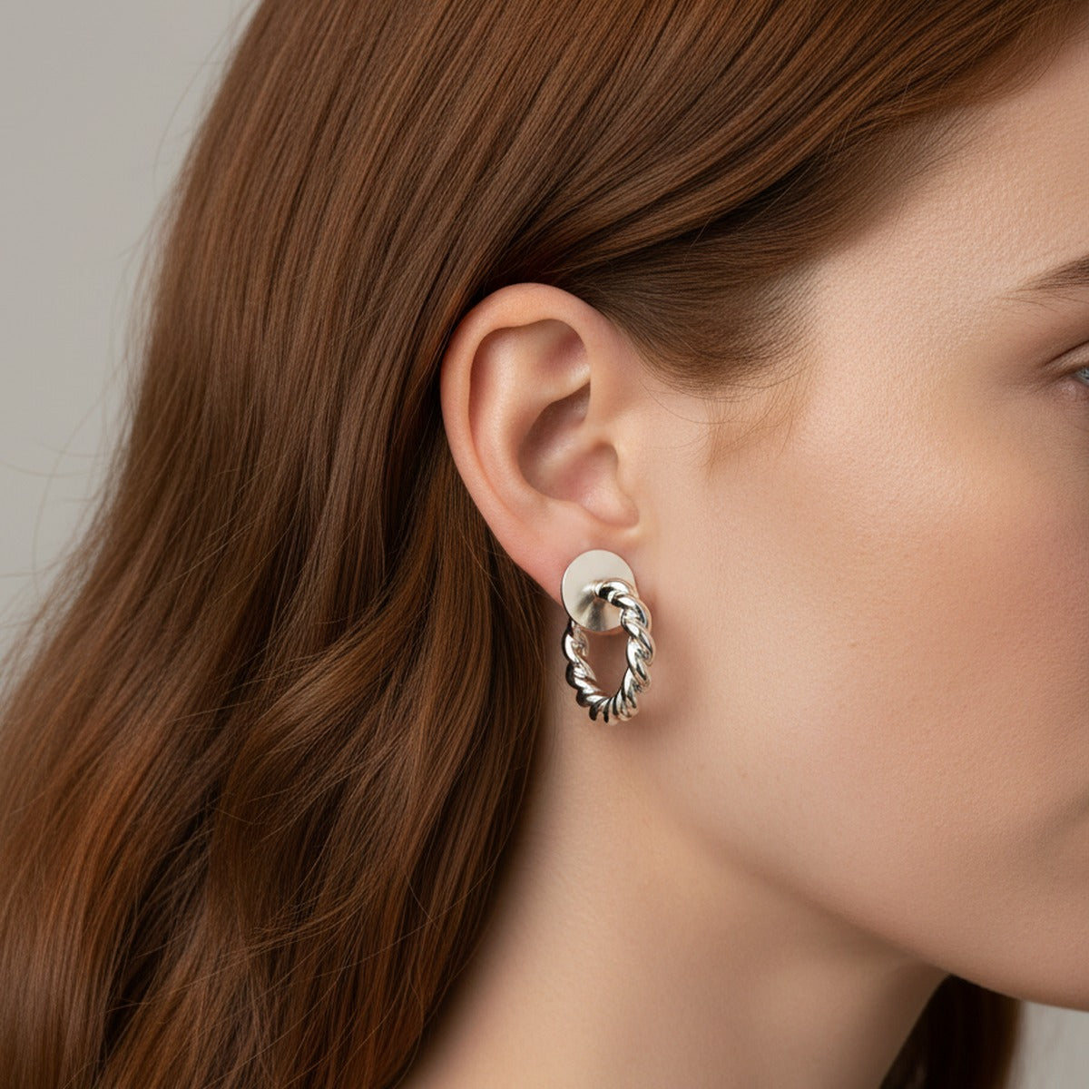 A twisted white gold hoop worn level