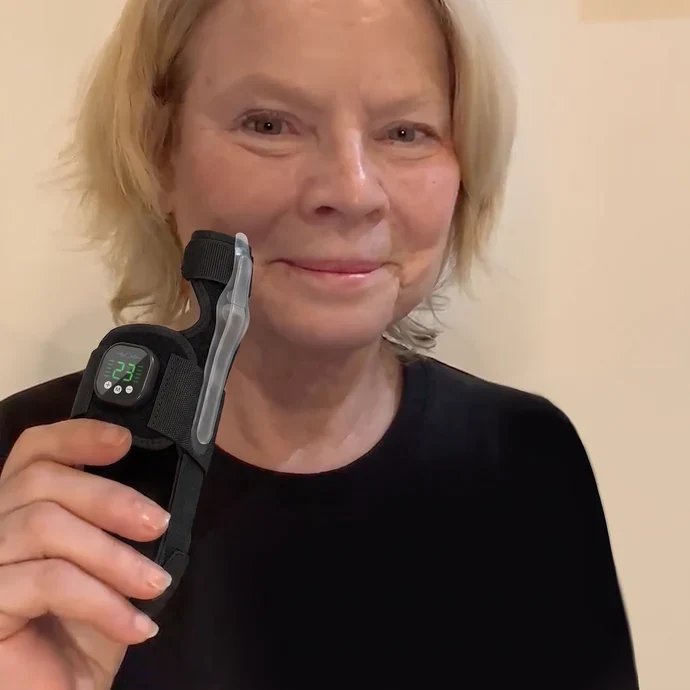 Carol holding the Avera support next to her face