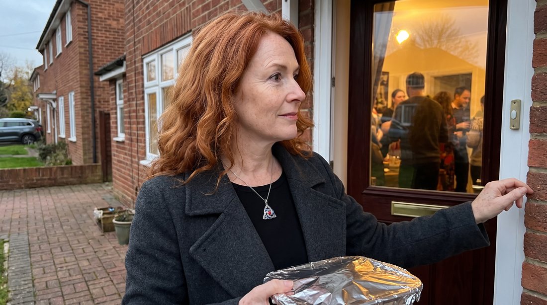 A woman arriving at a family party wearing the witch knot necklace
