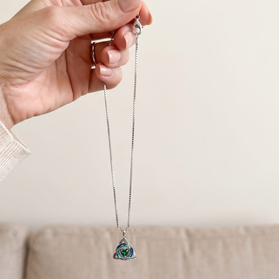 The necklace held up by its clasp