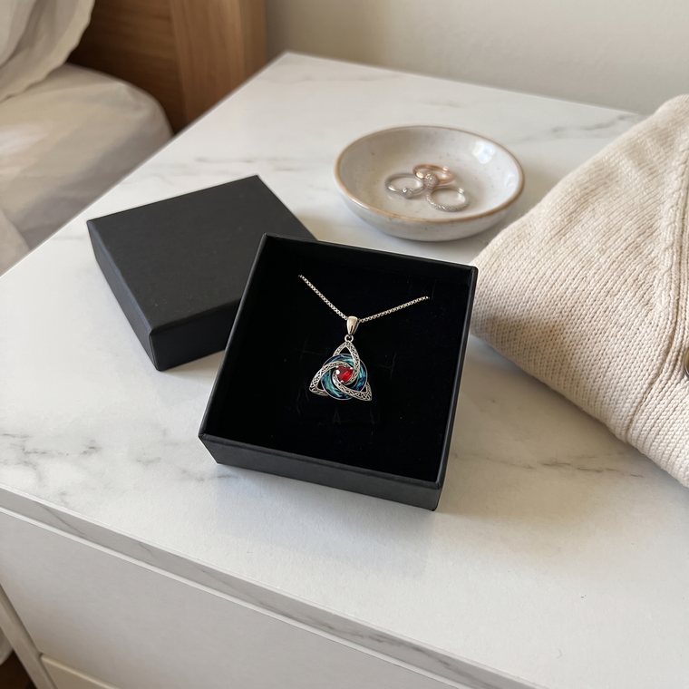 The necklace in its open black jewellery box