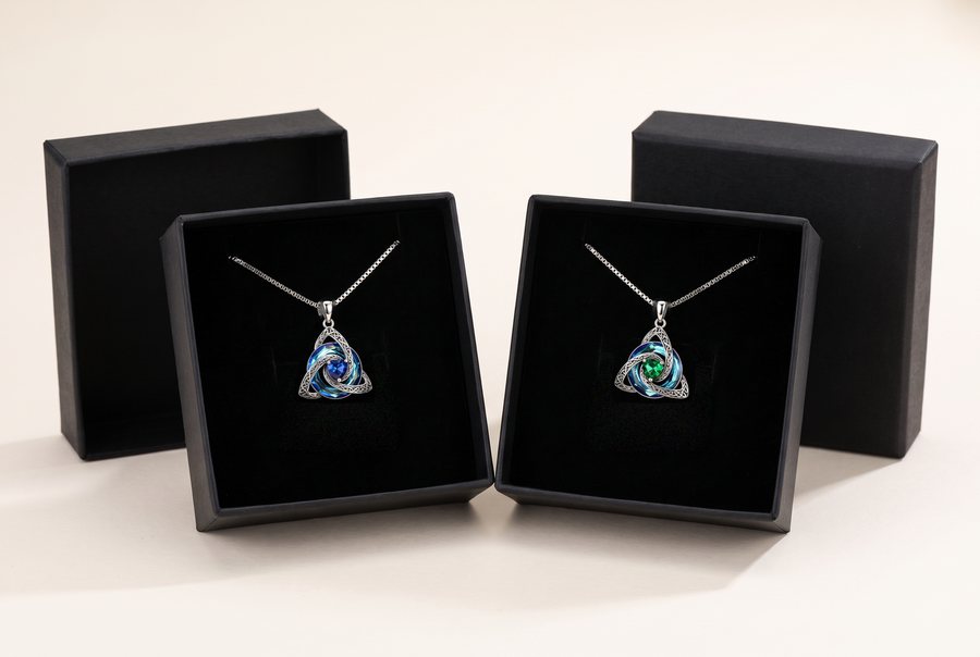 Two Witch Knot Birthstone Necklaces in their open boxes