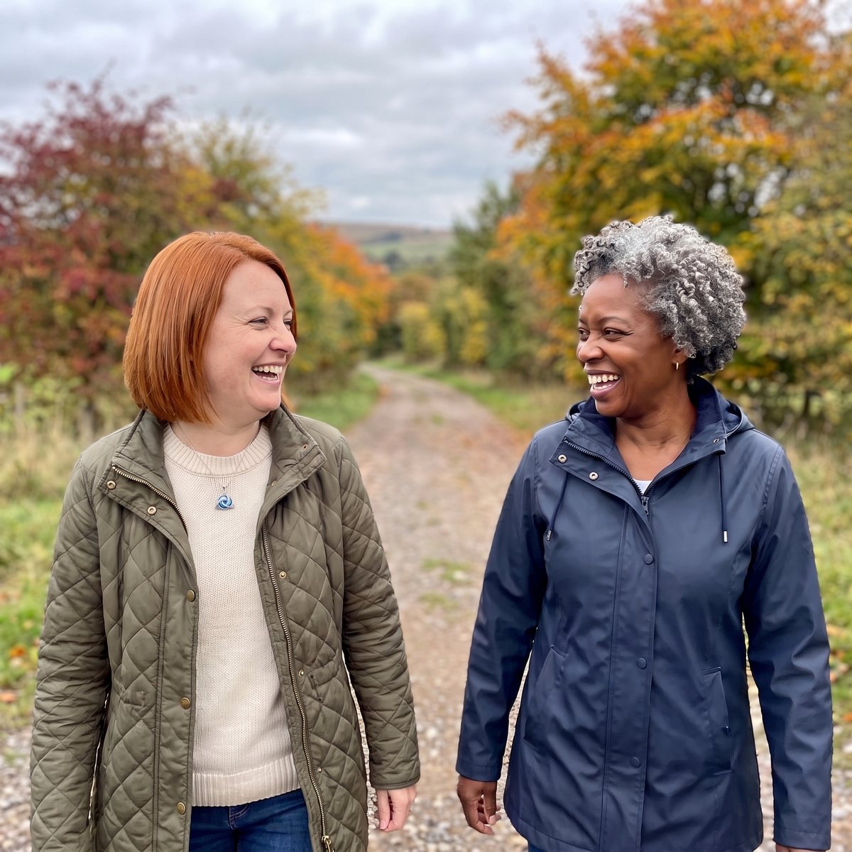 Two friends laughing on an autumn walk